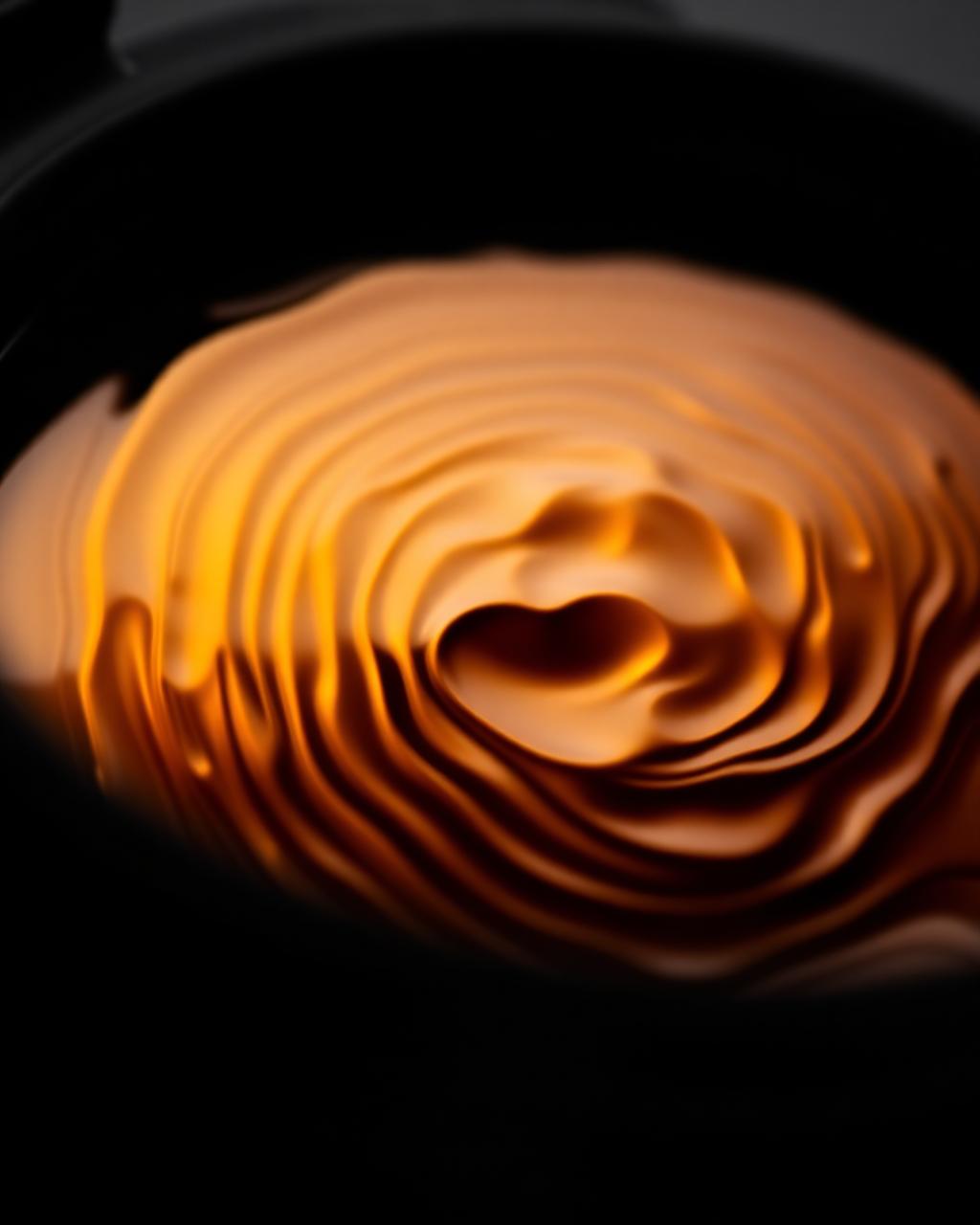 Macro detail of amber industrial oil ripple